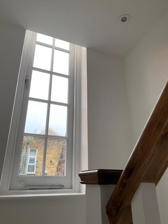 Bay of frosted and clear glass windows in NW3