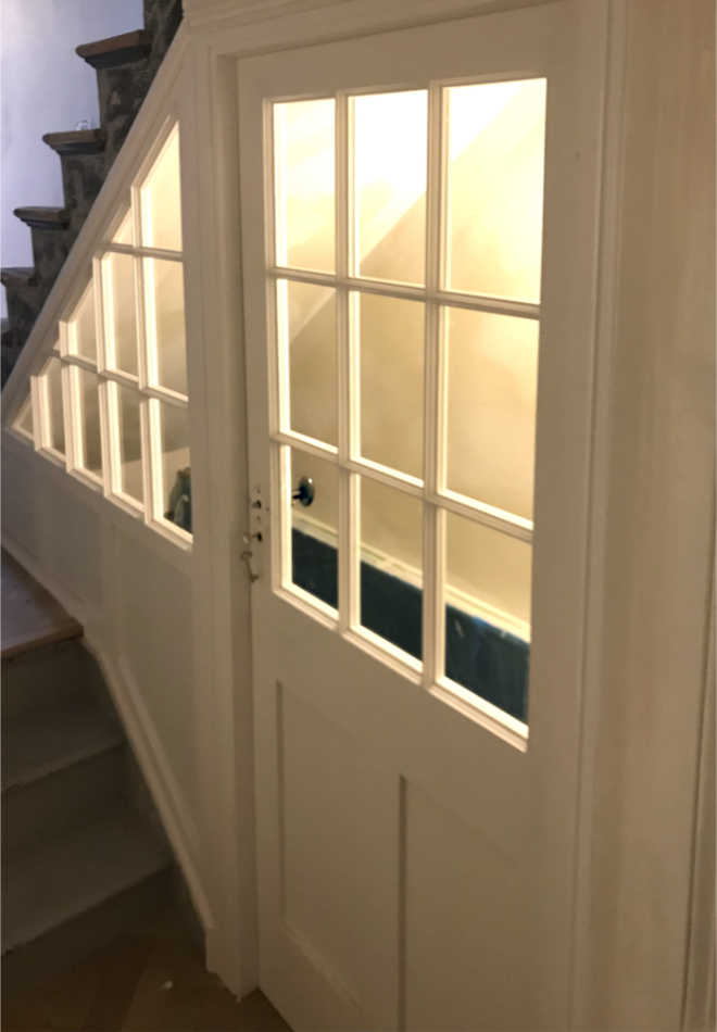 Bespoke door and side panes, letting light into stairwell to basement